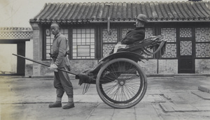 A man in a rickshaw with a cigar, Peking