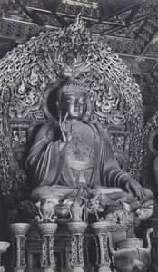 Statue of Buddha, with ritual objects, Peking