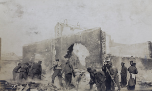 Raking over smouldering remains after a fire (Peking Mutiny), Peking 1912