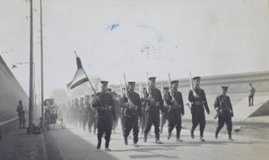 Republican soldiers marching, with a five-coloured flag