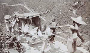A man and a child in a sedan chair on their way up to Lushan